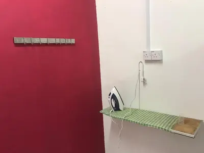 a room with a red door and a green shelf at Seri Manjung Homestay Wazer Residence in Lumut