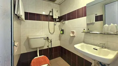 a bathroom with a toilet and a sink at Hotel 22 Gurney, Penang in George Town
