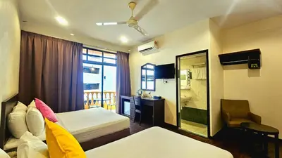 a hotel room with two beds and a mirror at Hotel 22 Gurney, Penang in George Town