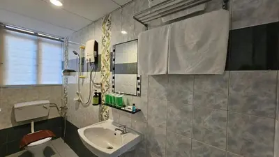 a bathroom with a sink and a toilet at Hotel 22 Gurney, Penang in George Town