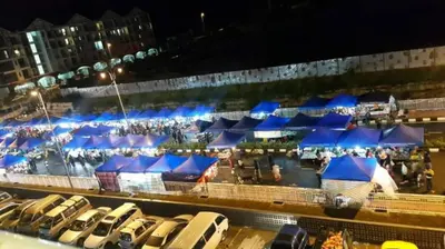 a row of blue umbrellas in a parking lot at night at Little Dream (Muslim) Homestay @ Cameron Highlands in Brinchang