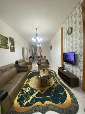 a living room with a couch and a table at SYA HONEY HOMESTAY with NETFLIX in Cameron Highlands