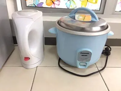a toaster sitting on a kitchen counter next to a white appliance at SYA HONEY HOMESTAY with NETFLIX in Cameron Highlands