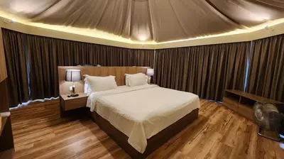 a bedroom with a large bed in a tent at Boulder Valley in Batu Ferringhi