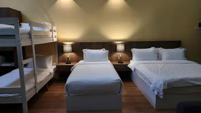 two beds in a room with two bunk beds at Boulder Valley in Batu Ferringhi