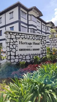 a hotel sign in front of a building at Cameron Greenhill Apartment in Cameron Highlands