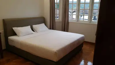a bedroom with a bed with two pillows on it at Cameron Greenhill Apartment in Cameron Highlands