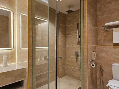 a shower with a glass door in a bathroom at Hompton Hotel by the Beach in George Town