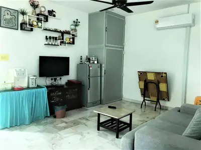 a living room with a couch and a tv at Ks Homestay in Taiping