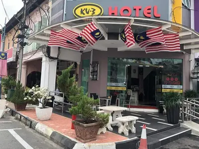 a hotel with american flags in front of it at KU-3 HOTEL in Tapah