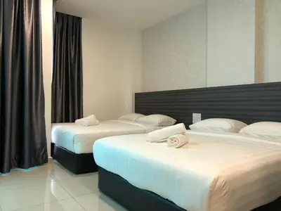 a hotel room with two beds with white sheets at KU-3 HOTEL in Tapah