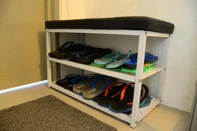 a shelf full of shoes in a room at The Woodz Thematic Homestay - Cameron Highlands Golden Hills Night Market in Cameron Highlands