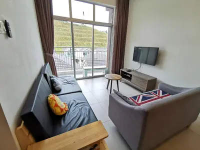 a living room with a couch and a tv at The Woodz Thematic Homestay - Cameron Highlands Golden Hills Night Market in Cameron Highlands