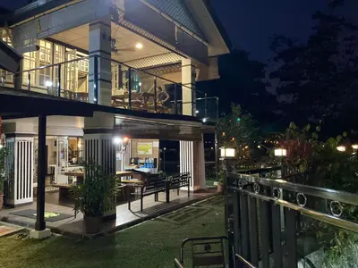 a large house with a balcony at night at Hickory Penang Hill in George Town