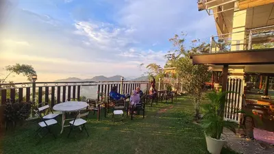 a group of people sitting at a table on a patio at Hickory Penang Hill in George Town