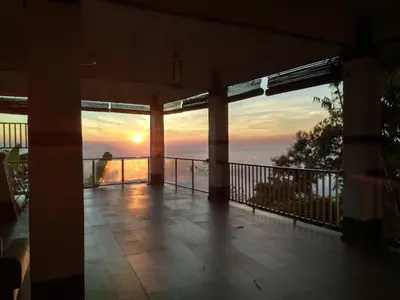 a view from the balcony of a house with the sunset at Hickory Penang Hill in George Town