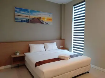 a bedroom with a large white bed with a window at MD Boutique Hotel in Kampar