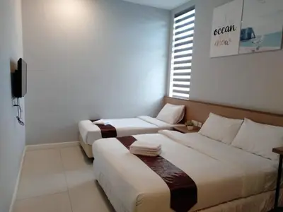 a room with two beds and a television in it at MD Boutique Hotel in Kampar