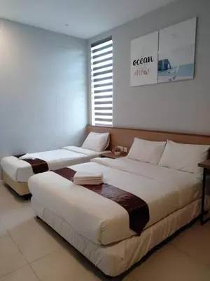 two large beds in a room with a window at MD Boutique Hotel in Kampar