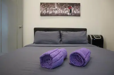a bed with purple crocheted pillows on it at Dudu Guesthouse Kuala Kangsar in Kuala Kangsar