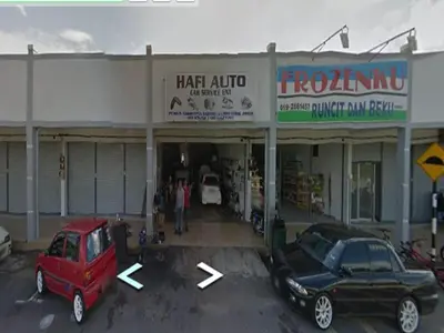 two cars parked in front of a car dealership at GERIK BANDING HOMESTAY in Gerik