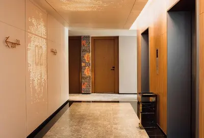 a hallway with doors and a tile floor at Victoria Garden Hotel in George Town