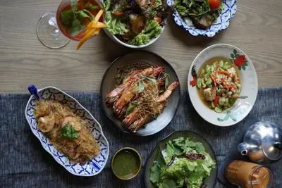 a table topped with plates of food and salads at Victoria Garden Hotel in George Town