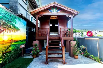 a wooden house with a staircase leading up to it at The Best Hotel in Bayan Lepas - THE LOV PENANG in Bayan Lepas