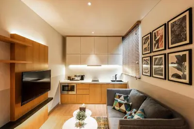 a living room with a couch and a table at Macalister Hotel Managed by The Ascott Limited in George Town