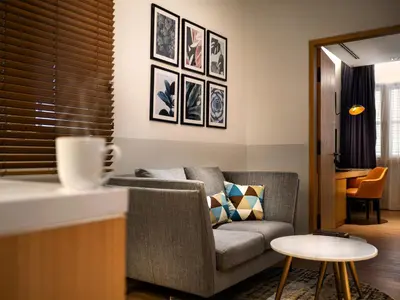 a living room with a couch and a table at Macalister Hotel Managed by The Ascott Limited in George Town