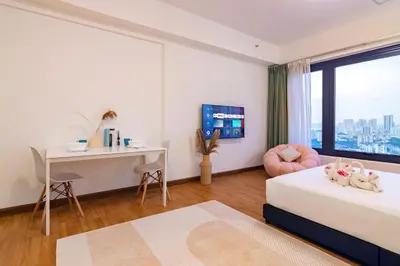 a bedroom with a desk and a bed and a desk and a chair at Tropicana 218 Macalister X Airlevate Suites in George Town