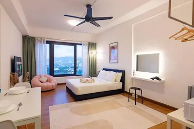 a living room with a bed and a ceiling fan at Tropicana 218 Macalister X Airlevate Suites in George Town