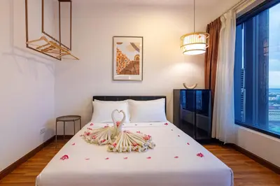 a bedroom with a bed with flowers on it at Tropicana 218 Macalister X Airlevate Suites in George Town