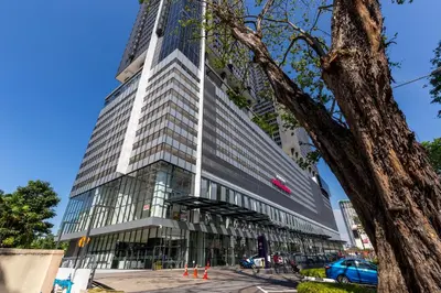 a tall building with orange cones in front of it at Tropicana 218 Macalister X Airlevate Suites in George Town