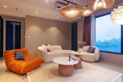 a living room with orange furniture and a large window at Tropicana 218 Macalister X Airlevate Suites in George Town