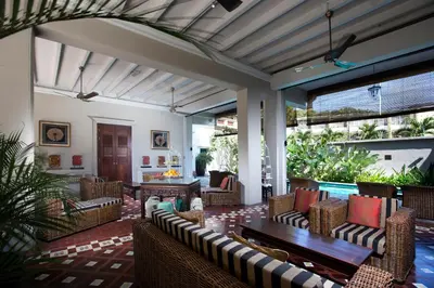 an outdoor patio with chairs and a table at Seven Terraces in George Town
