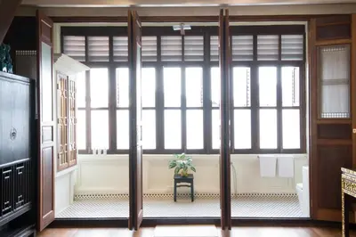 a room with a large window with a plant on a table at Seven Terraces in George Town
