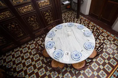a table with blue and white plates on it in a room at Seven Terraces in George Town