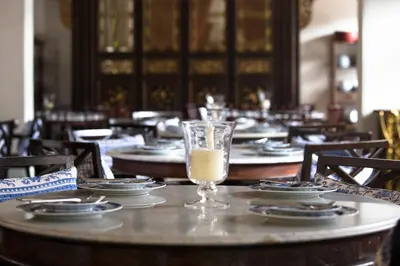 a table with plates and a glass of milk on it at Seven Terraces in George Town