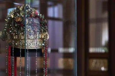 a golden crown with beads on a window at Seven Terraces in George Town