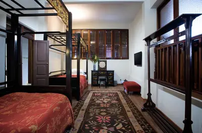 a bedroom with two beds and a bunk bed at Seven Terraces in George Town