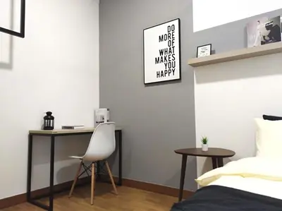a bedroom with a desk and a bed and a chair at Georgetown SeaView Condo Tropicana 218 Macalister in George Town