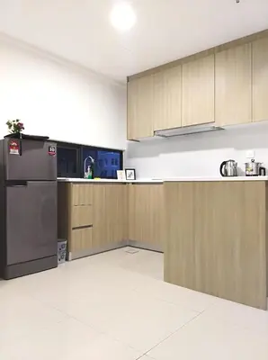a kitchen with wooden cabinets and a refrigerator at Georgetown SeaView Condo Tropicana 218 Macalister in George Town