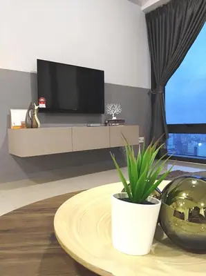 a living room with a tv and a table with a plant at Georgetown SeaView Condo Tropicana 218 Macalister in George Town