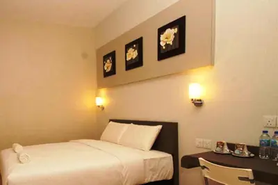 a hotel room with a bed and a desk at Ipoh Boutique Hotel in Ipoh