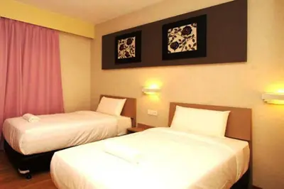 a hotel room with two beds in a room at Ipoh Boutique Hotel in Ipoh