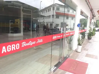 a red sign on the side of a building at Hotel Agro in Raub