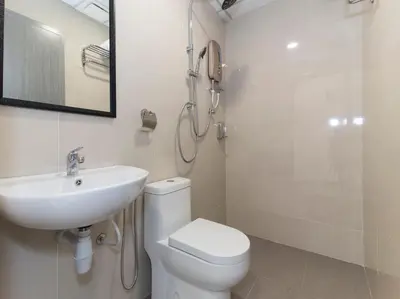 a bathroom with a toilet and a sink and a shower at Hotel Agro in Raub