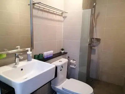 a bathroom with a white sink and a toilet at 218 Tropicana Georgetown Penang #B30 2BR for 4-7pax\u6e29\u99a8\u7a9d\u8212\u9002\u4e24\u623f in George Town