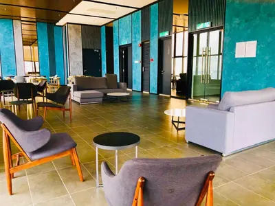 a lobby with chairs and tables in a building at 218 Tropicana Georgetown Penang #B30 2BR for 4-7pax\u6e29\u99a8\u7a9d\u8212\u9002\u4e24\u623f in George Town